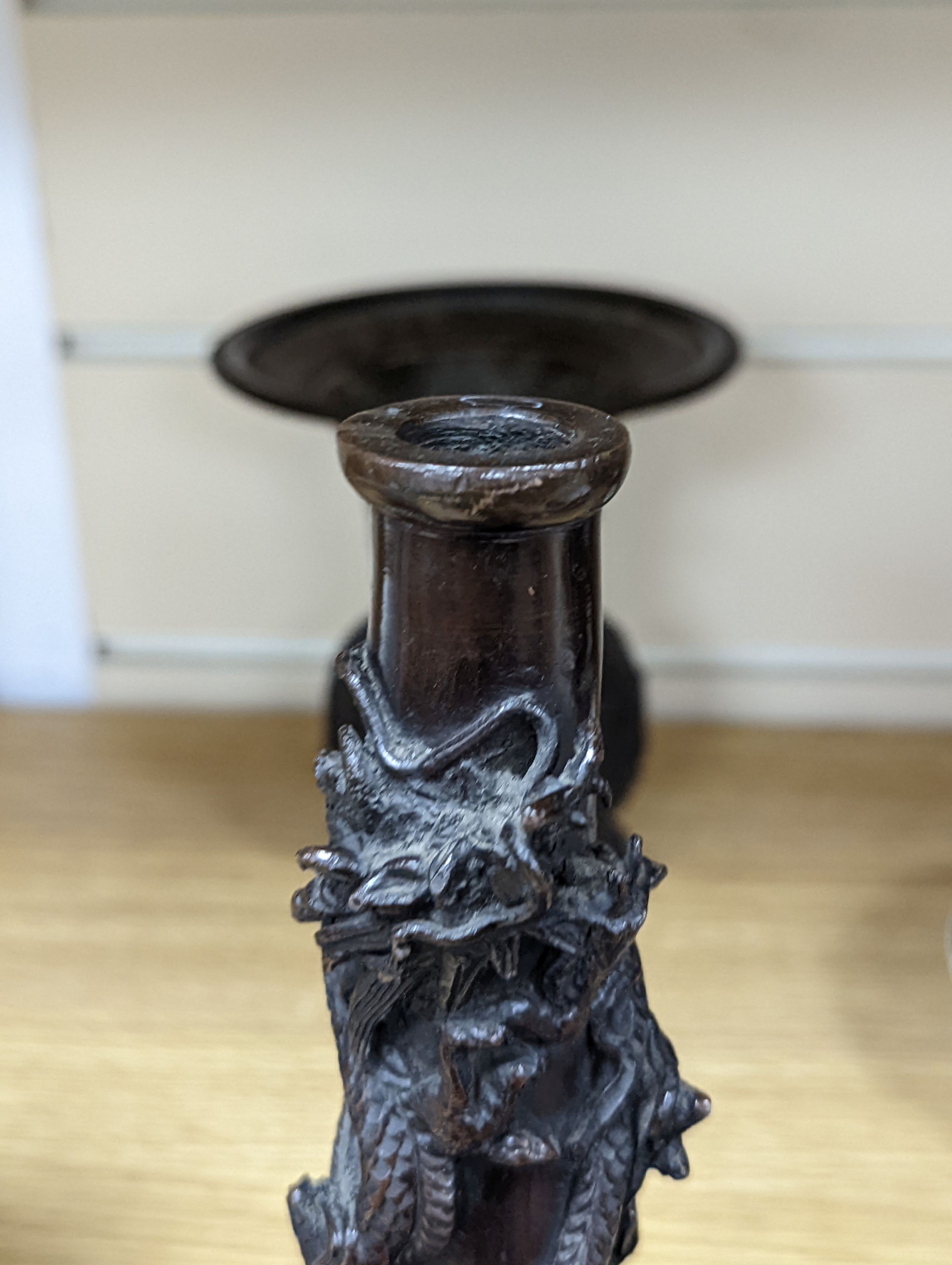 A pair of Japanese Meiji period bronze ‘dragon’ bottle vases and another, 21cm